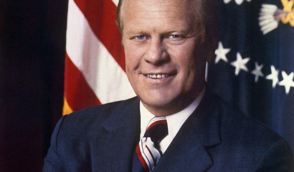 Official presidential portrait of Gerald Ford, smiling in a dark suit with the American flag behind him.