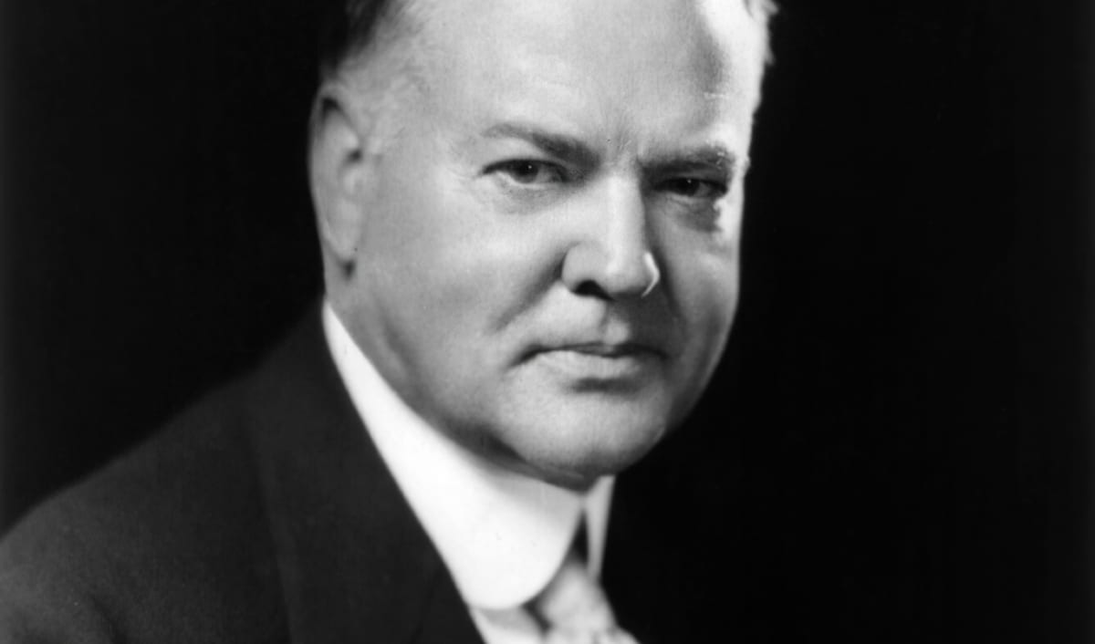Herbert Hoover in a photographic presidential portrait, in a dark suit and tie.