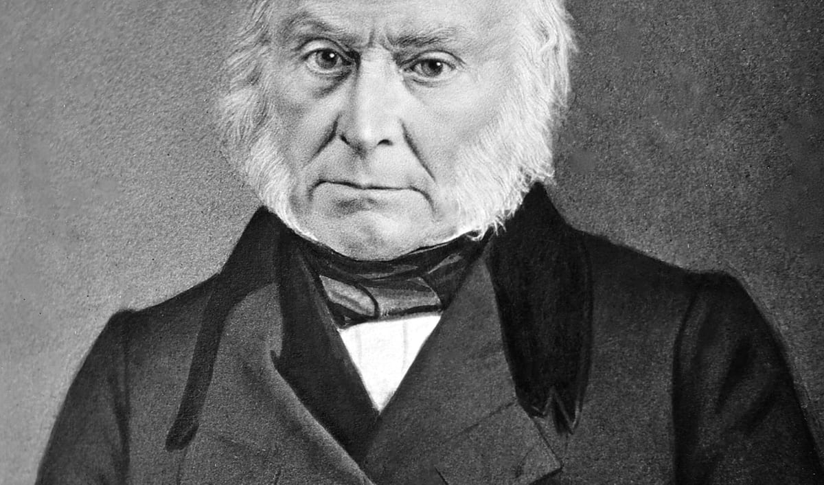 John Quincy Adams in an early photographic portrait, seated in a dark coat.